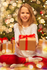 Image showing smiling girl with christmas gift at home