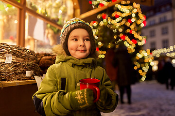 Image showing happy boy with cup of tea at christmas market