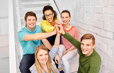 Image showing teenage friends or students making high five