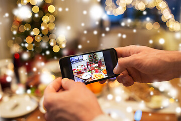 Image showing hands photographing food at christmas dinner