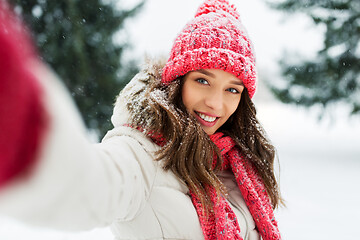 Image showing smiling woman taking selfie outdoors in winter