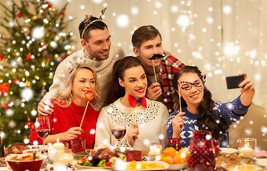 Image showing friends taking selfie at christmas dinner