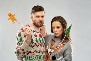 Image showing couple with christmas party props in ugly sweaters