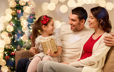 Image showing happy family with christmas present at home