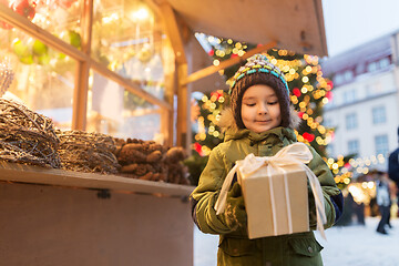 Image showing happy boy with gift box at christmas market