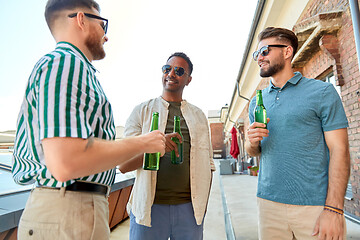 Image showing happy male friends drinking beer at rooftop party