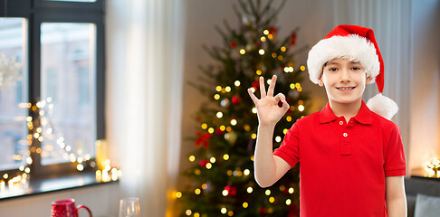 Image showing smiling boy in santa helper hat showing ok gesture