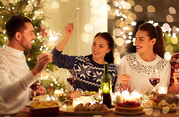 Image showing happy friends celebrating christmas at home feast