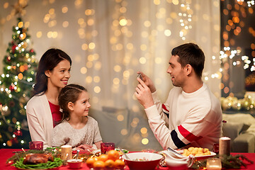 Image showing happy family taking picture at christmas dinner