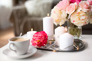 Image showing coffee, candles, garland and flowers on table