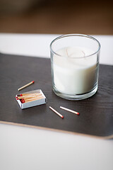 Image showing fragrance candle and matches on tray on table