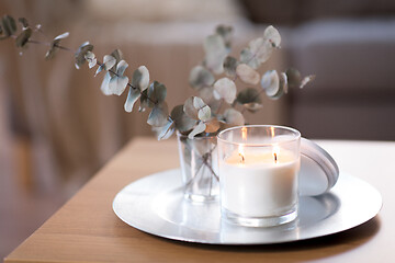 Image showing burning fragrance candle on table at cozy home