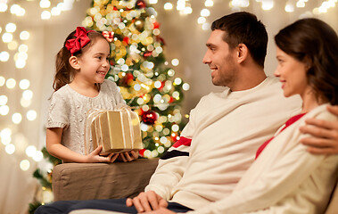 Image showing happy family with christmas present at home