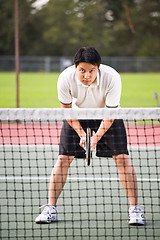 Image showing Asian male playing tennis