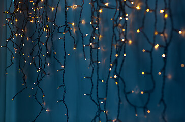 Image showing christmas garland lights over dark blue background