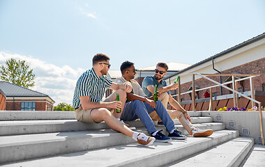 Image showing happy male friends drinking beer on street