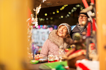 Image showing senior couple at christmas market souvenir shop