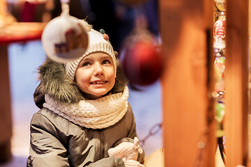 Image showing happy little girl at christmas market in winter