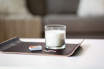 Image showing fragrance candle and matches on tray on table