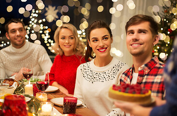 Image showing happy friends having christmas dinner at home