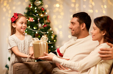 Image showing happy family with christmas present at home