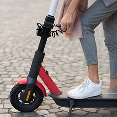 Image showing User unlocking rental electric scooter. Eco friendly green modern urban mobility concept of sharing transportation with electric scooters for rent in Ljubljana, Slovenia