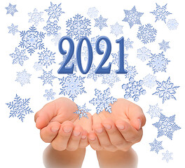 Image showing Flying snowflakes from woman’s cupped hands with 2021 text