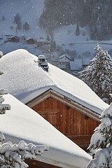 Image showing Winter mountain village, roof and chimney covered with snow