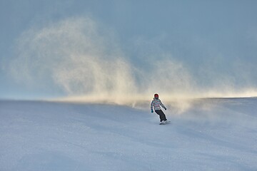 Image showing Female snowboarder fast on a slope