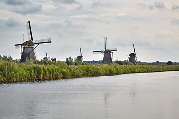 Image showing Windmill beside a canal