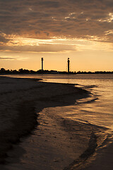 Image showing Two lighthouses on the island near sea at sunset