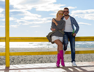 Image showing young couple drinking beer together at the beach