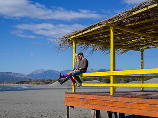 Image showing young couple drinking beer together at the beach