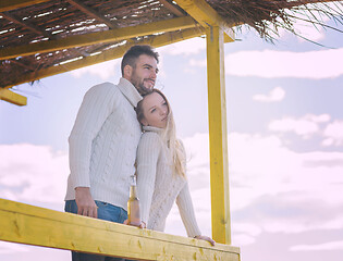 Image showing young couple drinking beer together at the beach