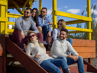 Image showing Group of friends having fun on autumn day at beach