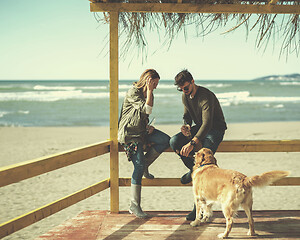 Image showing young couple with a dog at the beach