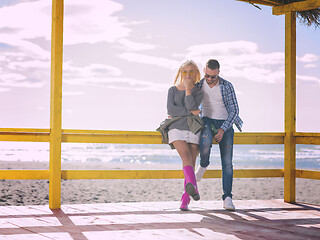 Image showing young couple drinking beer together at the beach