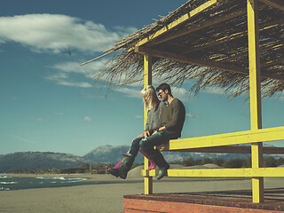 Image showing young couple drinking beer together at the beach