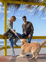 Image showing young couple with a dog at the beach