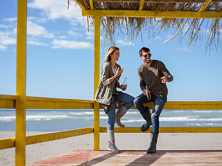 Image showing young couple drinking beer together at the beach