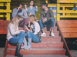 Image showing Group of friends having fun on autumn day at beach