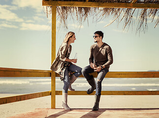 Image showing young couple drinking beer together at the beach