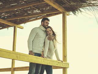 Image showing young couple drinking beer together at the beach