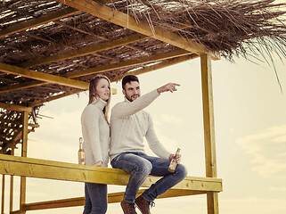 Image showing young couple drinking beer together at the beach