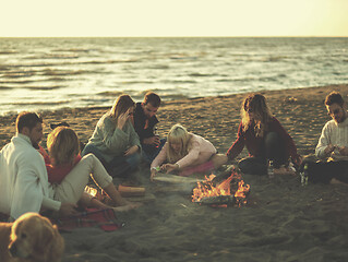 Image showing Friends having fun at beach on autumn day