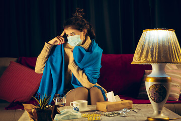 Image showing Woman wrapped in a plaid wearing face mask trying to protect from somebody\'s sick