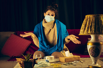 Image showing Woman wrapped in a plaid wearing face mask trying to protect from somebody\'s sick