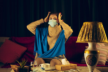 Image showing Woman wrapped in a plaid wearing face mask trying to protect from somebody\'s sick