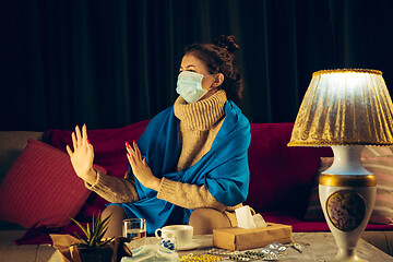 Image showing Woman wrapped in a plaid wearing face mask trying to protect from somebody\'s sick