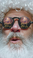 Image showing Close-up Santa Claus in glasses with a reflection of 2021 Happy New Year